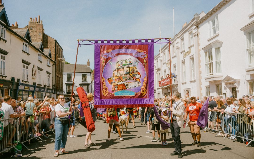 Image of equity banner being displayed outside of county hotel during durham miners gala 2022