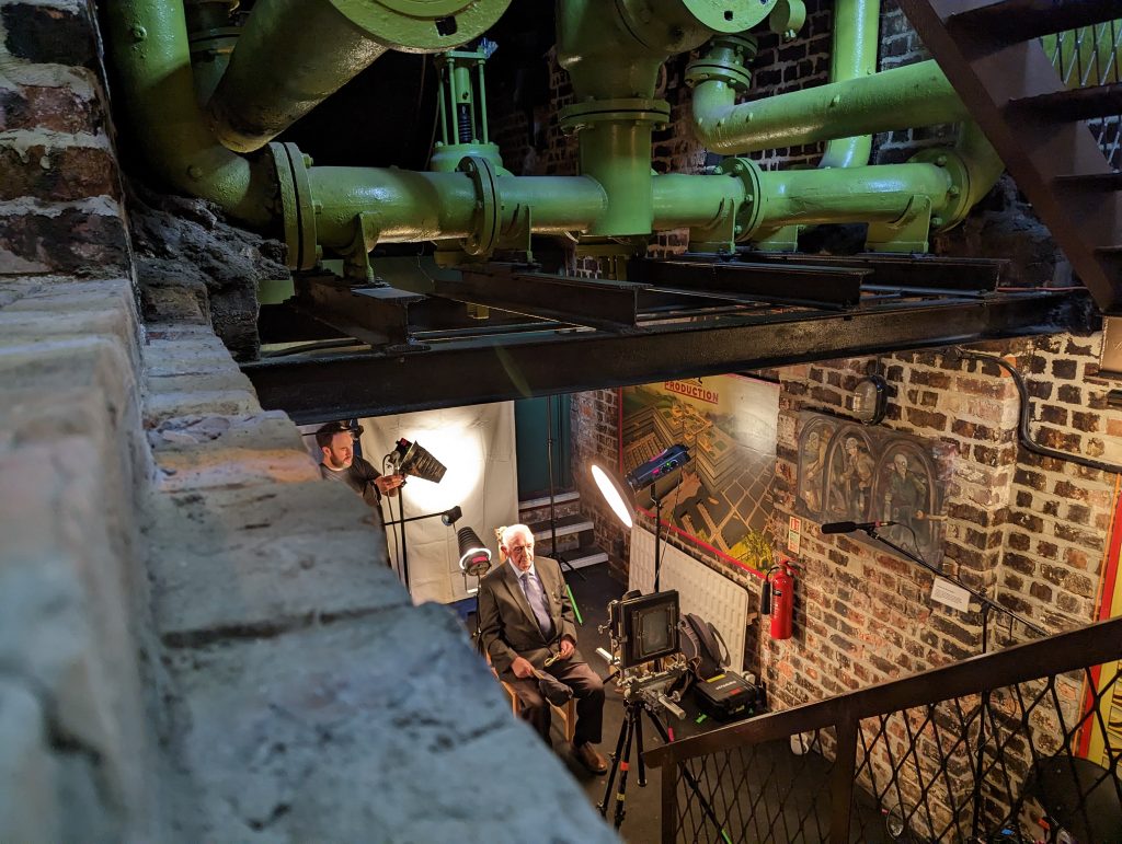 Any Martin taking tintype portraits of Joe Humes at Washington f pit in May 2023. Image taken from the stair case.